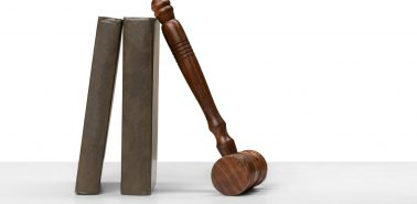 Wooden gavel and books on wooden table